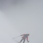 Tom skiing off the summit into the fog